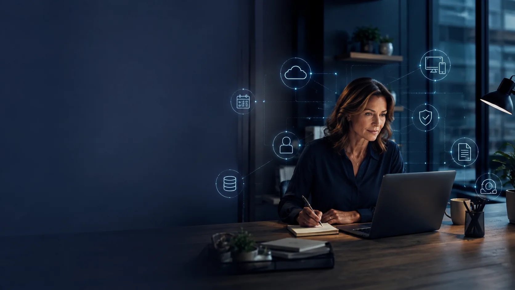 Business owner at a laptop with digital systems and dependencies in view